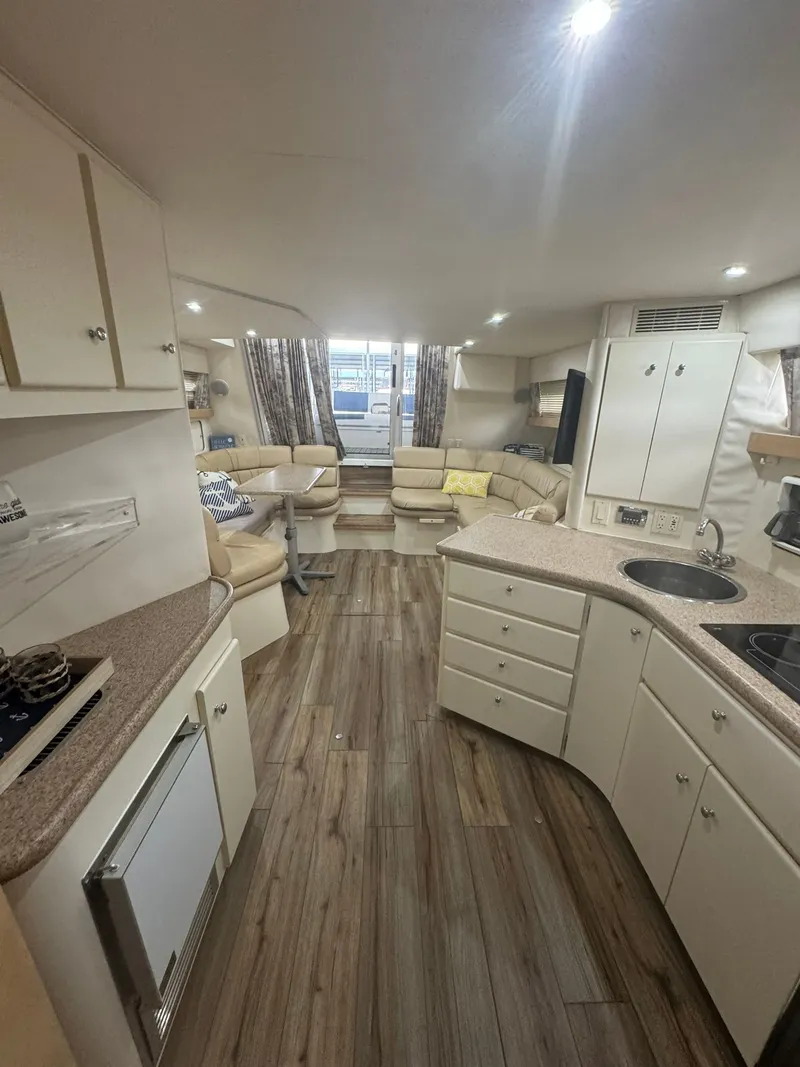 Slide: The Image of Interior of a 1997 Carver 380 Santego yacht with modern kitchen and seating area. - 14