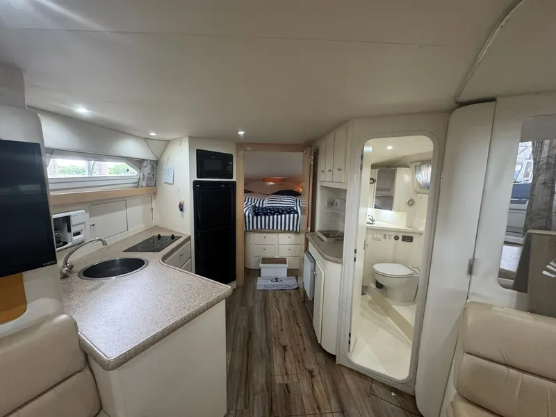 Slide: The Image of Interior of a 1997 Carver 380 Santego yacht with kitchen, bed, and bathroom. - 16