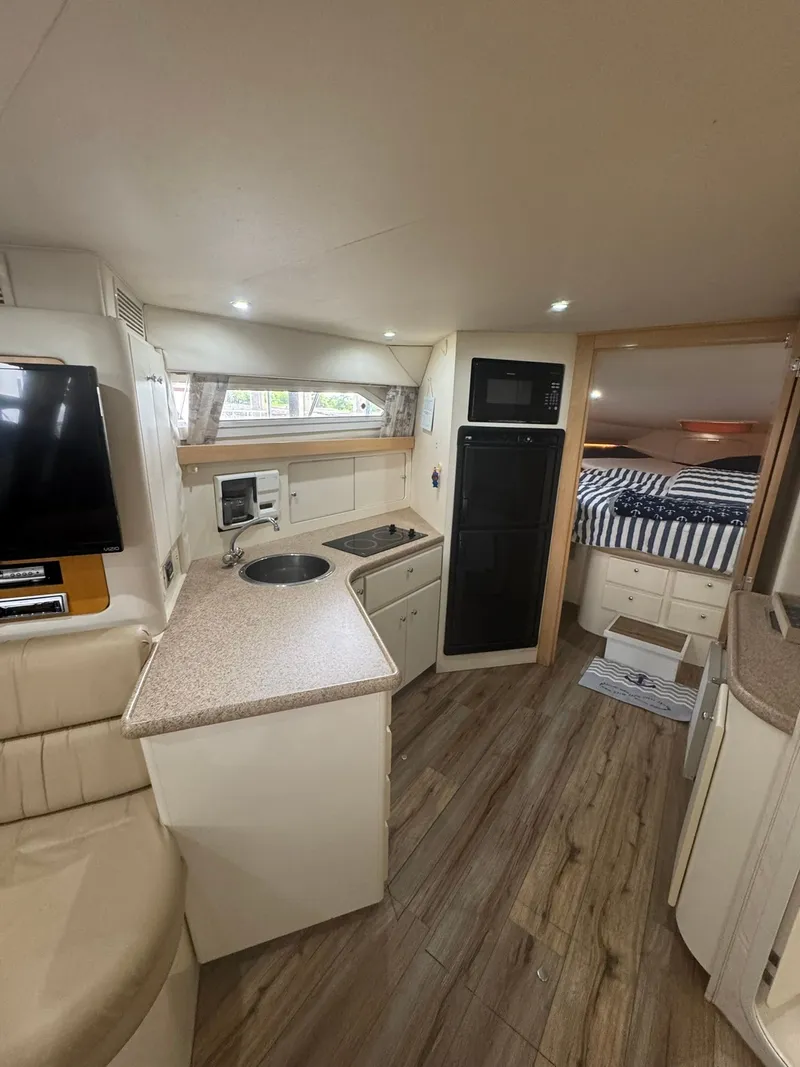 Slide: The Image of Interior of 1997 Carver 380 Santego yacht with kitchenette and cozy sleeping area. - 17