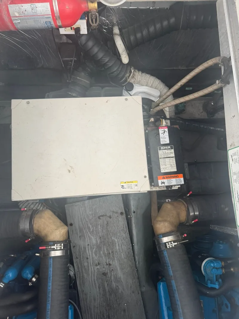 Slide: The Image of Engine compartment of a 1997 Carver 380 Santego with visible hoses and equipment. - 24