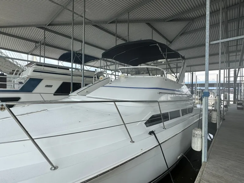 Slide: The Image of 1997 Carver 380 Santego yacht docked in a covered marina. - 3