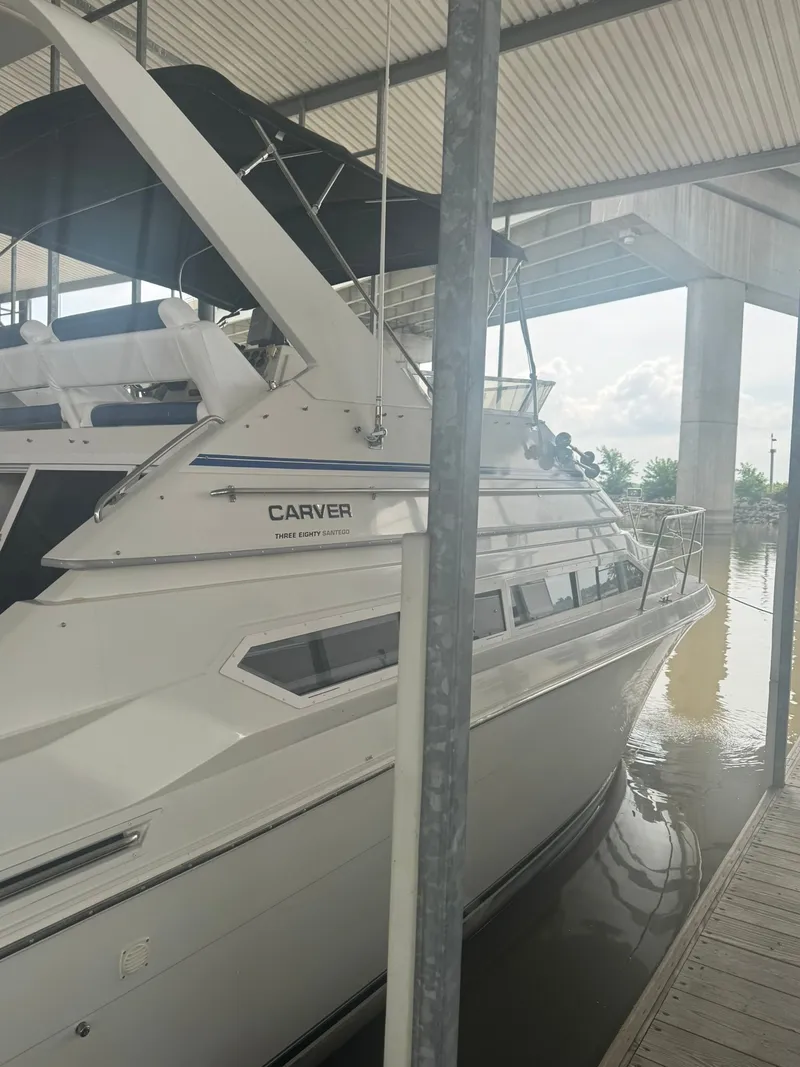 Slide: The Image of 1997 Carver 380 Santego yacht docked under a covered marina. - 4