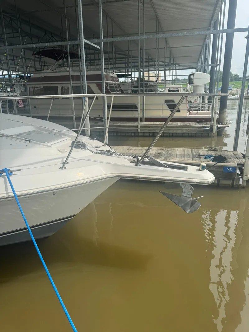 Slide: The Image of 1997 Carver 380 Santego yacht docked in a marina with visible anchor. - 6