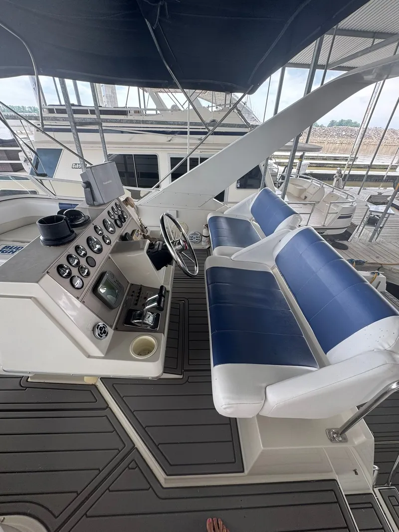 Slide: The Image of 1997 Carver 380 Santego yacht helm with blue seating and control panel. - 8