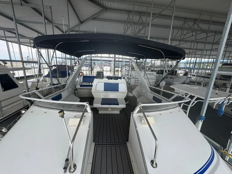 Slide: The Image of 1997 Carver 380 Santego yacht interior with seating under a covered dock. - 9