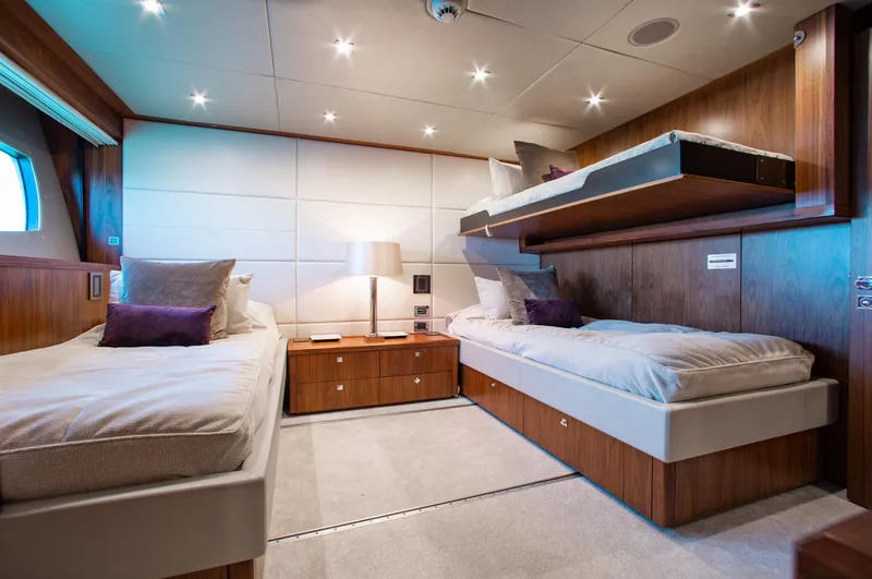 Slide: The Image of Luxurious bedroom interior of 2014 Sunseeker 131 yacht with wood paneling and large bed. - 25