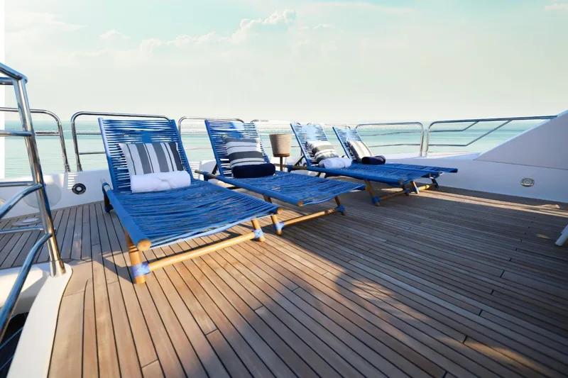 Slide: The Image of Sunseeker 131 yacht deck with blue loungers, ocean view, 2014 model. - 46