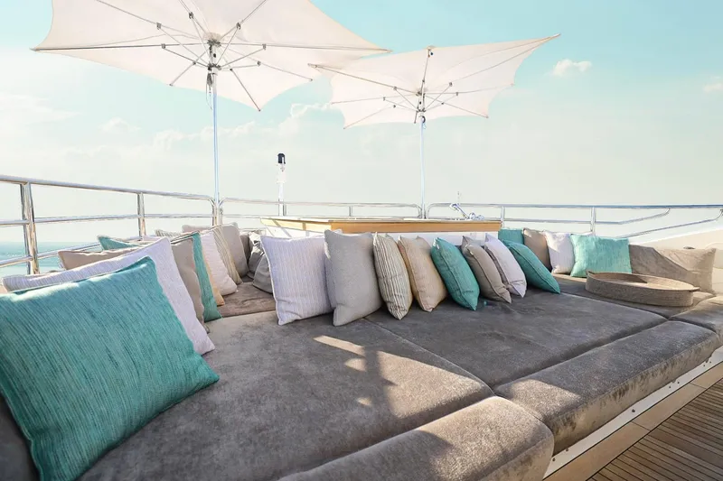 Slide: The Image of Luxurious Sunseeker 131 yacht deck with plush seating, cushions, and umbrellas, 2014 model. - 51