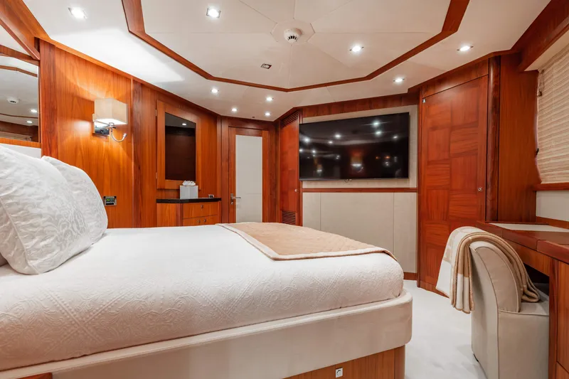 Slide: The Image of Luxurious bedroom interior of 2009 Sunseeker 121 yacht with wood paneling and large TV. - 23