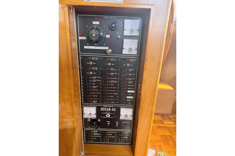 Slide: The Image of Interior view of 1988 Ocean Alexander 42' yacht with striped cushions and marina backdrop. - 11