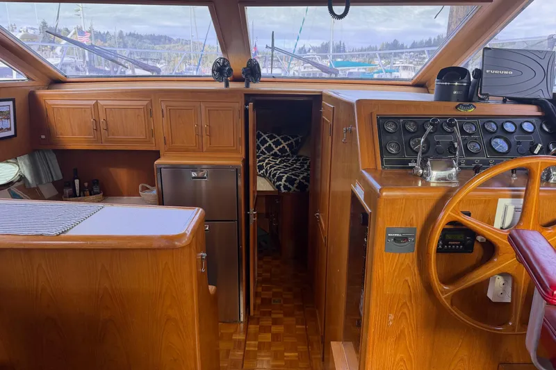 Slide: The Image of 1988 Ocean Alexander 42' yacht interior with striped seating and marina view. - 14