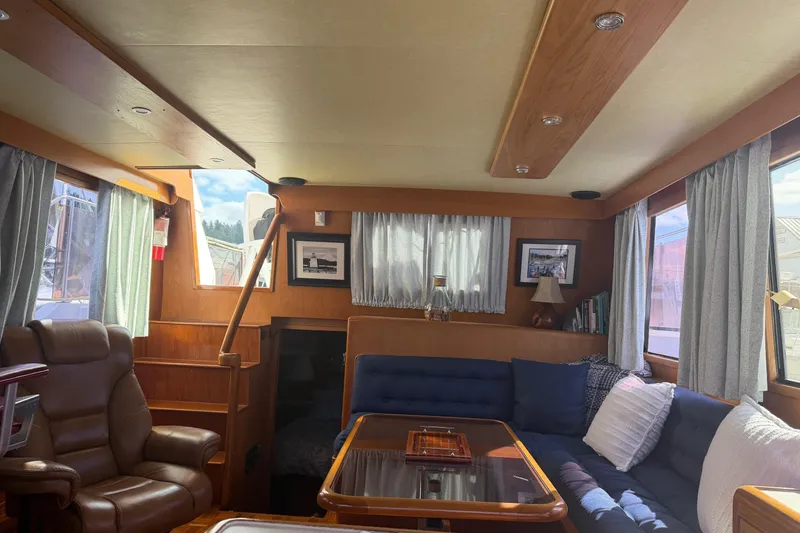 Slide: The Image of Luxurious 1988 Ocean Alexander 42' yacht interior with wood finish and panoramic windows. - 17