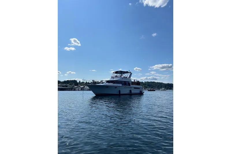 Slide: The Image of 1988 Ocean Alexander 42' yacht on calm water under a clear blue sky. - 2