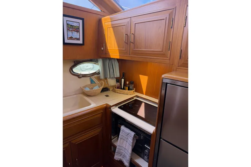 Slide: The Image of Interior of 1988 Ocean Alexander 42' yacht kitchen with wooden cabinetry and countertop. - 26