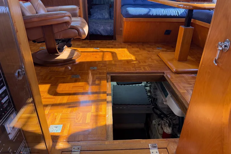 Slide: The Image of 1988 Ocean Alexander 42' yacht kitchen with wooden cabinets, sink, and nautical decor. - 29