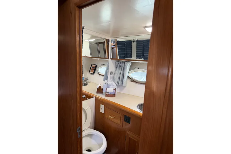 Slide: The Image of 1988 Ocean Alexander 42' yacht kitchen with microwave, fridge, and wooden cabinetry. - 30