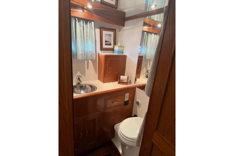 Slide: The Image of 1988 Ocean Alexander 42' yacht kitchen with wooden cabinets and modern appliances. - 31