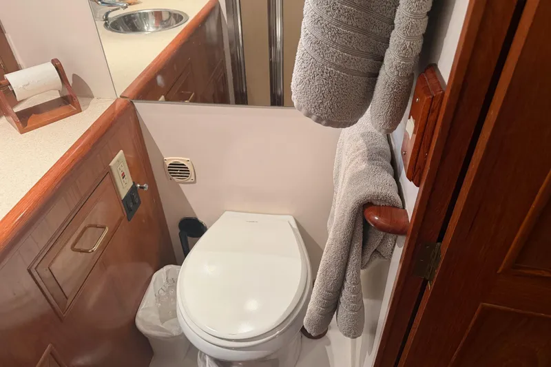 Slide: The Image of Interior view of 1988 Ocean Alexander 42' yacht, showcasing wooden finishes and helm area. - 33