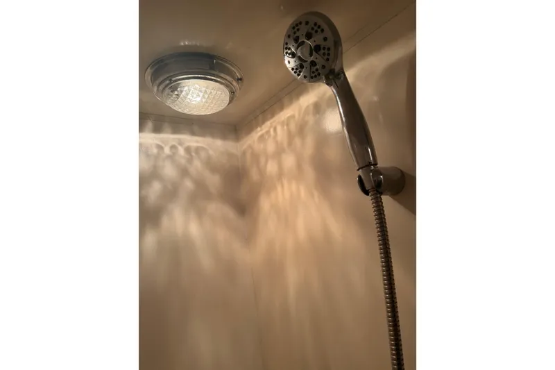 Slide: The Image of Interior of 1988 Ocean Alexander 42' yacht with open engine hatch and wooden flooring. - 34