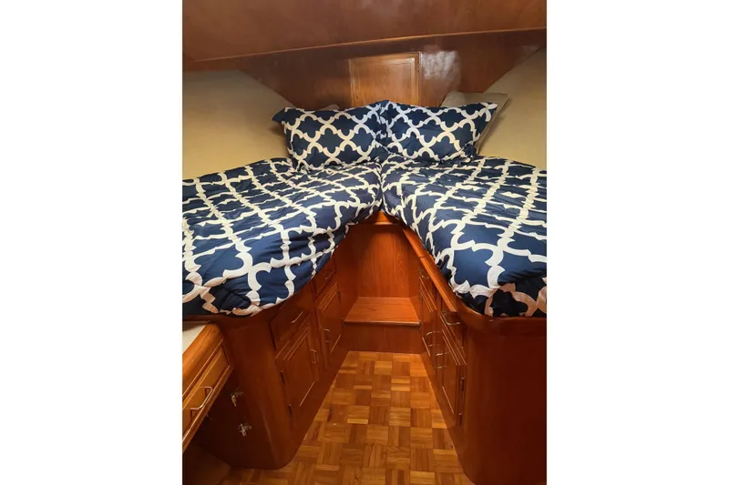 Slide: The Image of Cozy bedroom in 1988 Ocean Alexander 42' yacht with patterned bedding and elegant decor. - 42