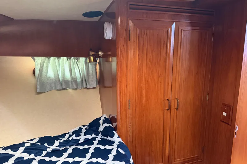 Slide: The Image of 1988 Ocean Alexander 42' yacht interior with wooden cabinetry and cozy bedroom. - 44