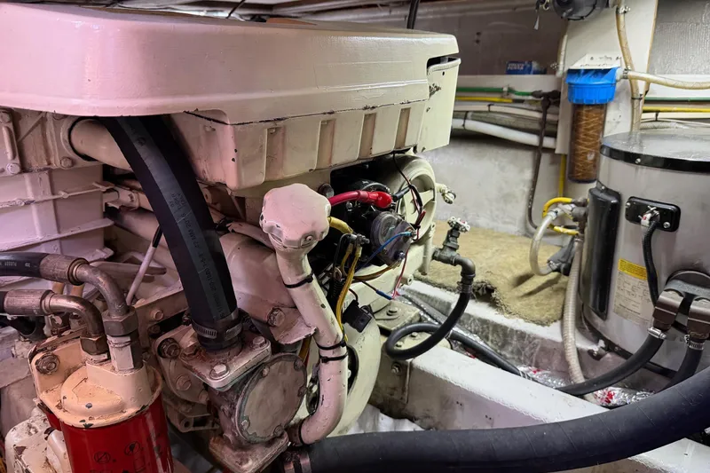 Slide: The Image of Engine room of 1988 Ocean Alexander 42' yacht, showcasing mechanical components and wiring. - 55