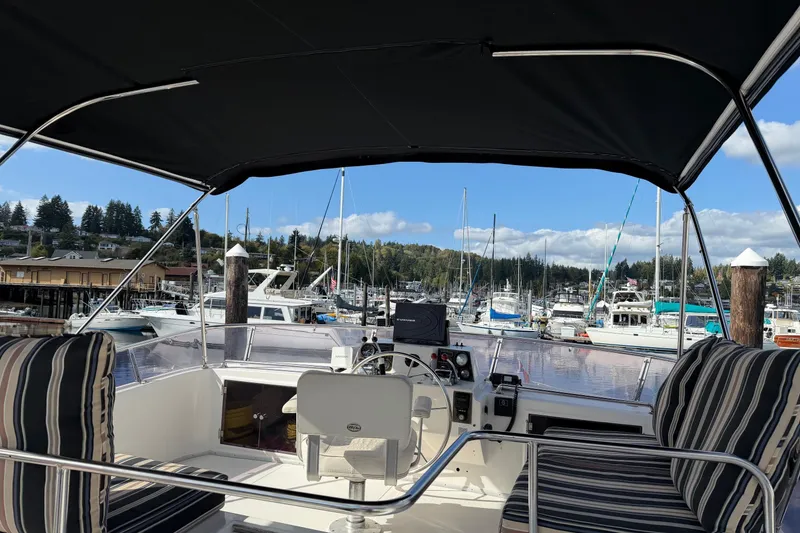 Slide: The Image of 1988 Ocean Alexander 42' yacht docked, featuring a black canopy and radar equipment. - 7