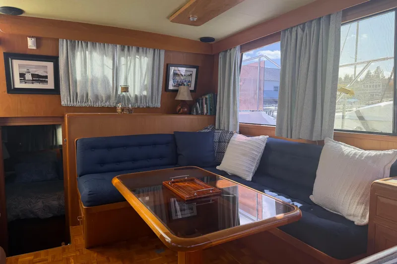 Slide: The Image of 1988 Ocean Alexander 42' yacht interior with wooden cabinetry, helm, and cozy cabin. - 19