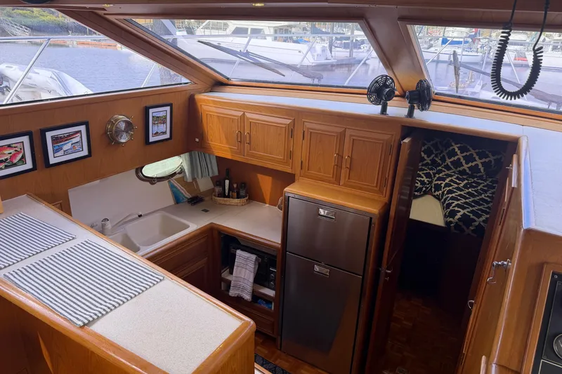 Slide: The Image of Interior of 1988 Ocean Alexander 42' yacht with cozy seating and wooden table. - 23