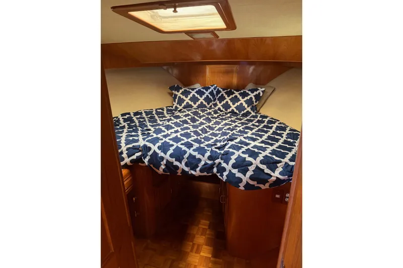 Slide: The Image of Cozy bedroom in 1988 Ocean Alexander 42' yacht with wood cabinetry and patterned bedding. - 43