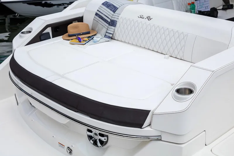 Slide: The Image of Luxurious seating area on a 2021 Sea Ray SLX 310 boat at a marina. - 11