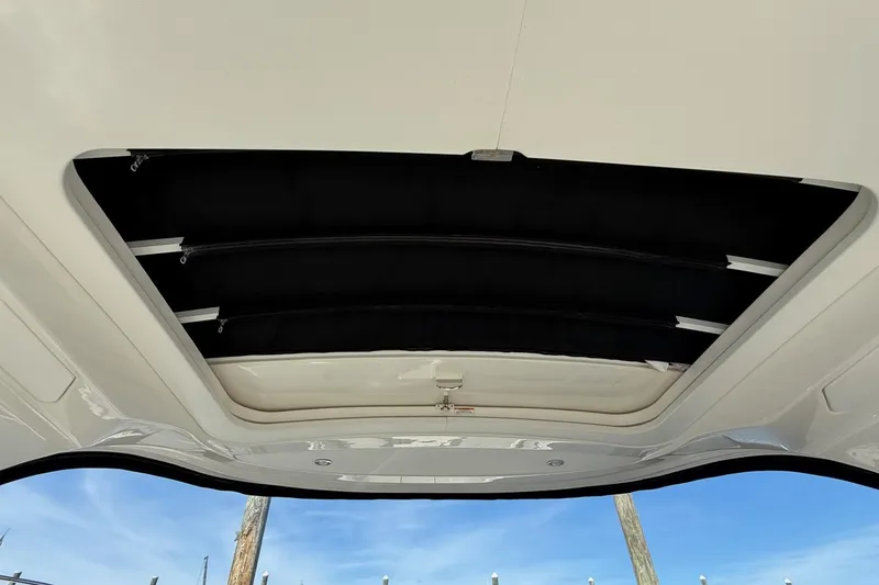 Slide: The Image of 2021 Sea Ray SLX 310 storage compartment with lock, featuring sleek design and durable materials. - 18