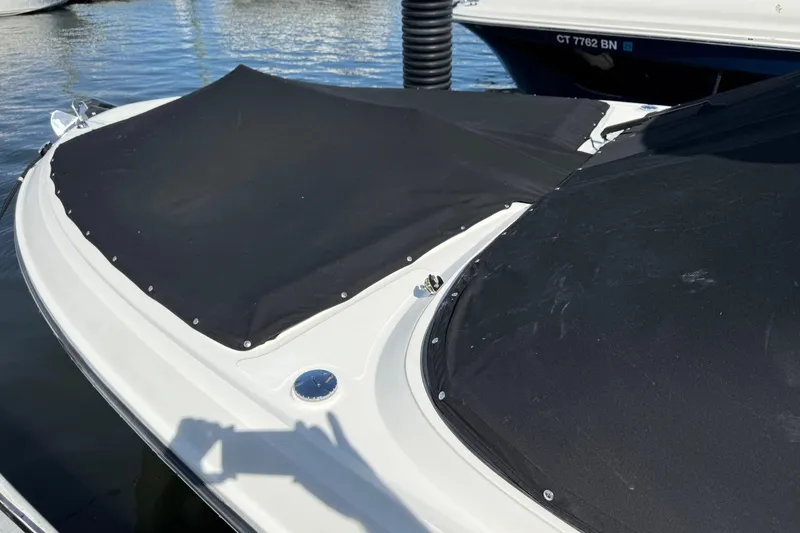 Slide: The Image of 2021 Sea Ray SLX 310 boat covered at marina dock. - 21