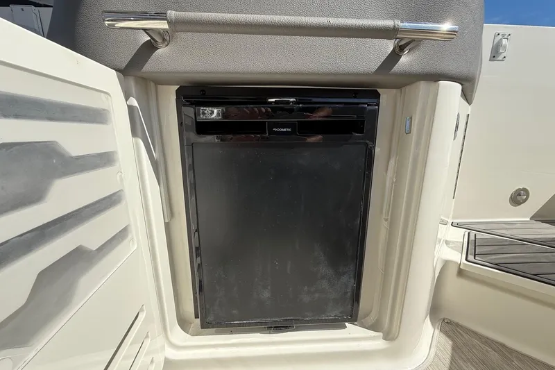 Slide: The Image of 2021 Sea Ray SLX 310 boat with black cover on water. - 22