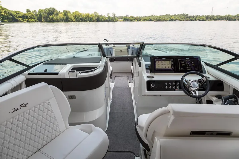 Slide: The Image of 2021 Sea Ray SLX 310 helm with navigation display and steering wheel. - 4