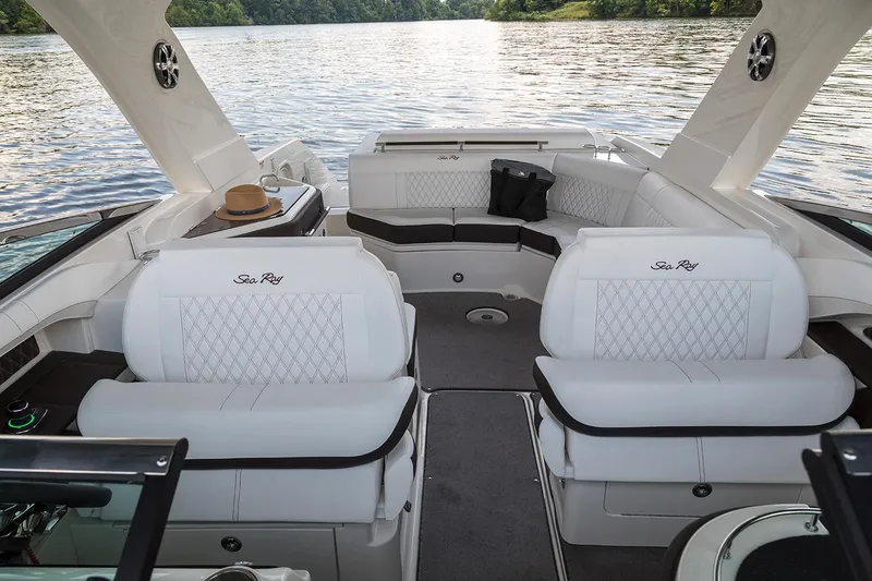Slide: The Image of 2021 Sea Ray SLX 310 boat interior with steering wheel and luxurious seating. - 6