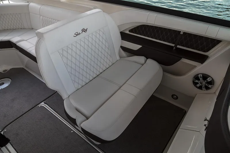 Slide: The Image of 2021 Sea Ray SLX 310 boat interior with steering wheel and plush seating. - 7