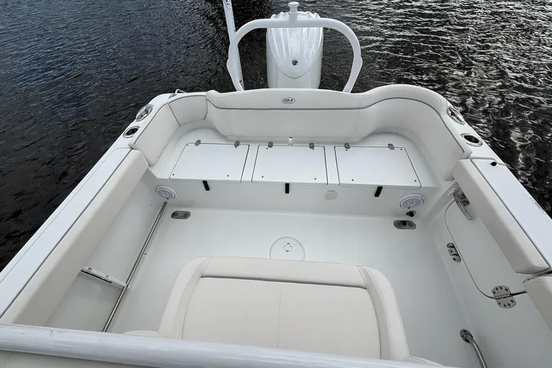 Slide: The Image of 2024 Sea Hunt Ultra 255 SE boat interior with white seating and steering console. - 12