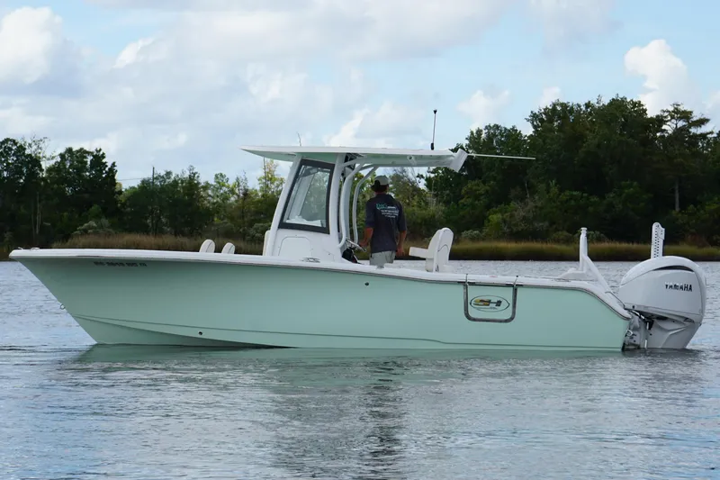 Slide: The Image of 2024 Sea Hunt Ultra 255 SE boat interior with open storage compartments at a dock. - 14