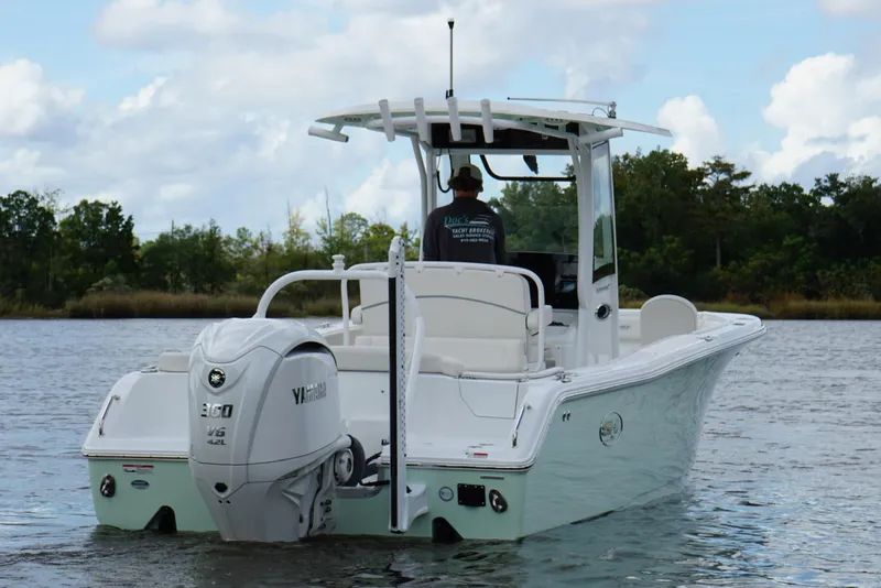 Slide: The Image of 2024 Sea Hunt Ultra 255 SE boat on calm water, featuring a Yamaha outboard motor. - 18
