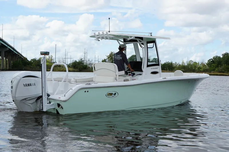 Slide: The Image of 2024 Sea Hunt Ultra 255 SE boat on calm water, featuring Yamaha engine. - 3