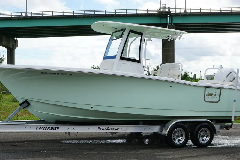 Slide: The Image of 2024 Sea Hunt Ultra 255 SE boat on trailer under bridge. - 4