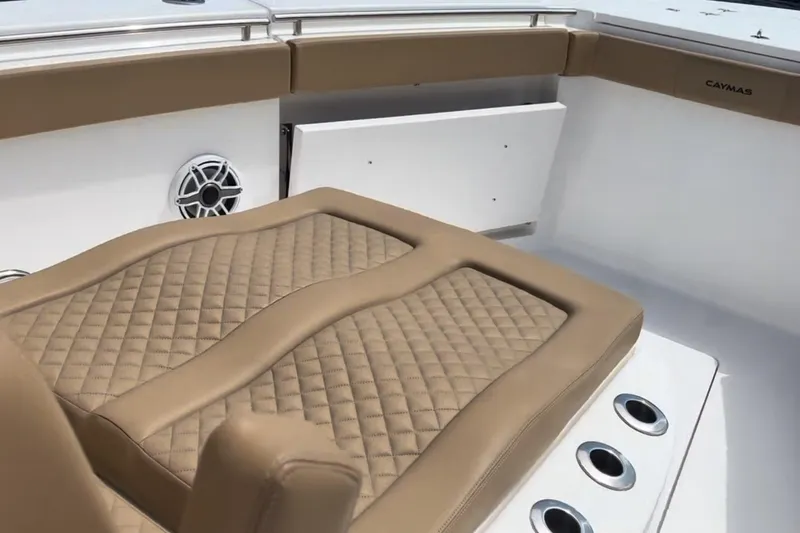 Slide: The Image of Luxurious seating on 2023 Caymas 341 CC boat with quilted tan upholstery. - 11