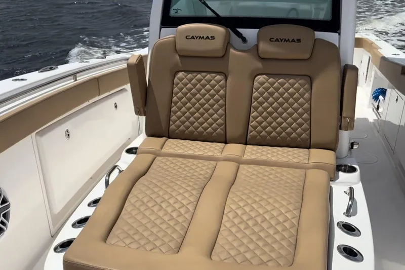 Slide: The Image of 2023 Caymas 341 CC boat with luxurious tan quilted seating on deck. - 15