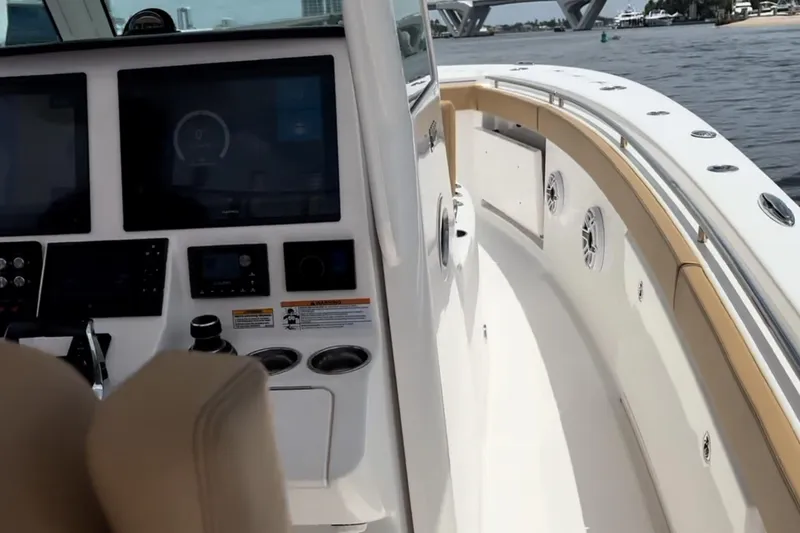 Slide: The Image of 2023 Caymas 341 CC boat interior with modern dashboard and spacious deck. - 19