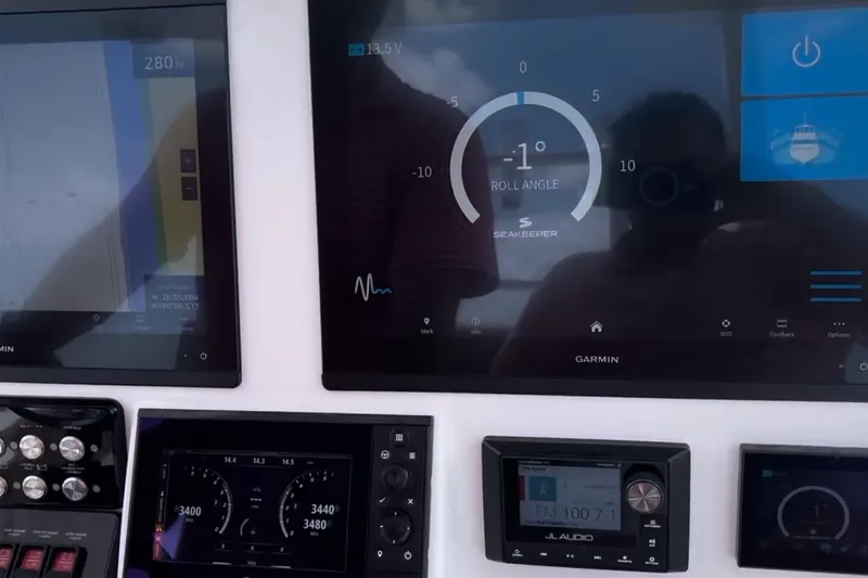 Slide: The Image of Control panel of 2023 Caymas 341 CC boat with Garmin displays and Seakeeper system. - 24