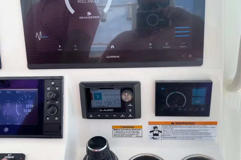 Slide: The Image of Control panel of 2023 Caymas 341 CC boat with Garmin and JL Audio displays. - 25