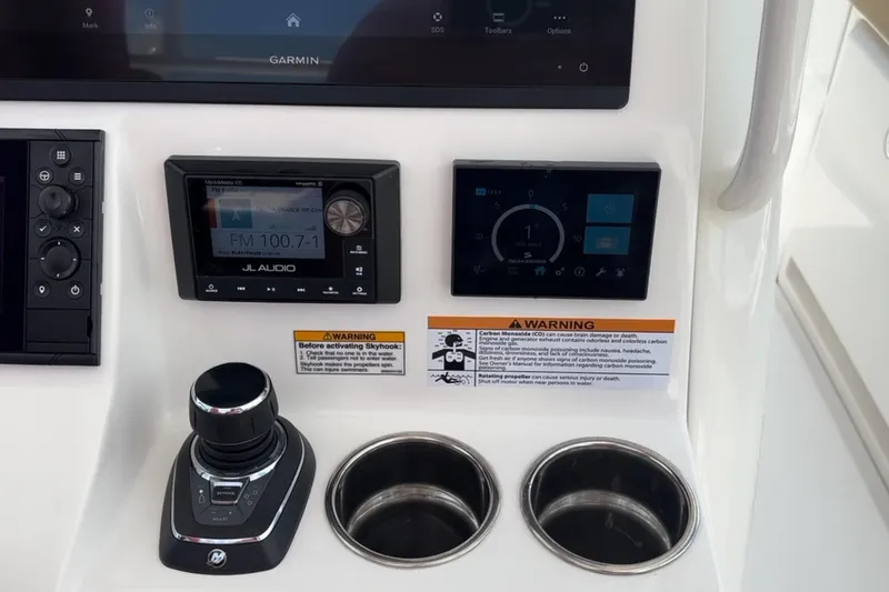 Slide: The Image of 2023 Caymas 341 CC dashboard with JL Audio system and Garmin display. - 26