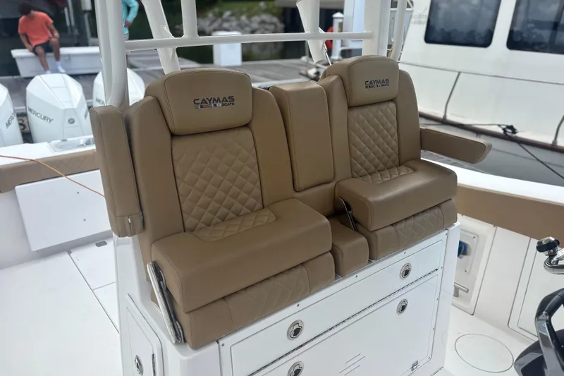 Slide: The Image of 2023 Caymas 341 CC boat with tan leather seating and storage compartments. - 29