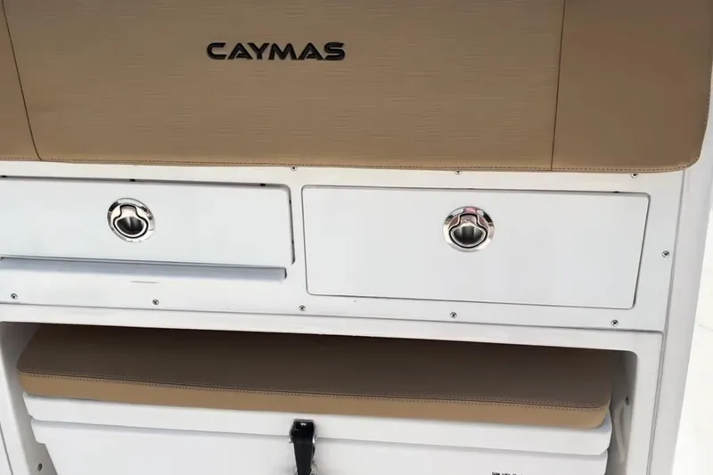 Slide: The Image of 2023 Caymas 341 CC boat interior storage compartments with beige accents. - 33